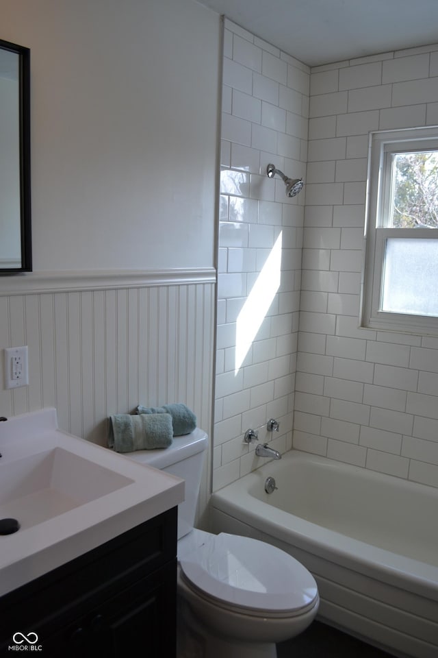 full bathroom with toilet, vanity, and tiled shower / bath combo