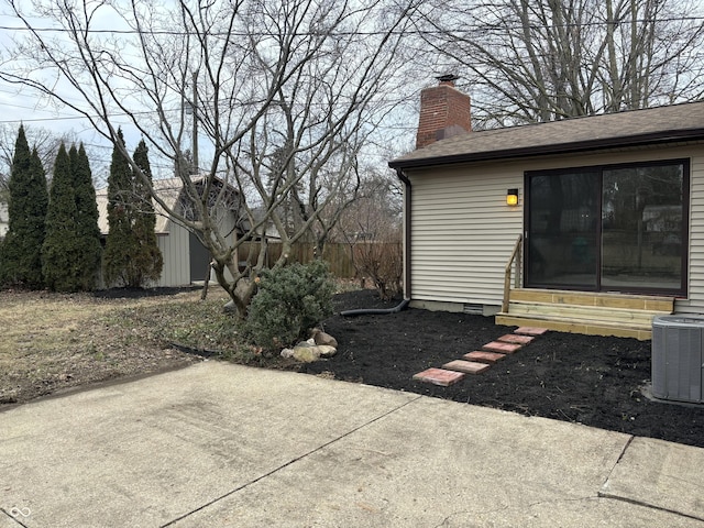 view of yard featuring central AC and a patio area