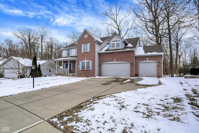 traditional home with a garage, driveway, brick siding, and a porch