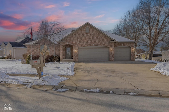 view of front of home with an attached garage, concrete driveway, and brick siding