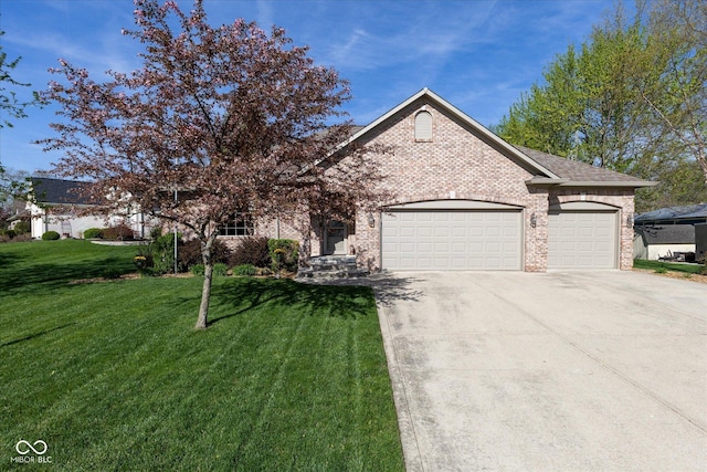 view of front of home featuring brick siding, a front yard, driveway, and an attached garage