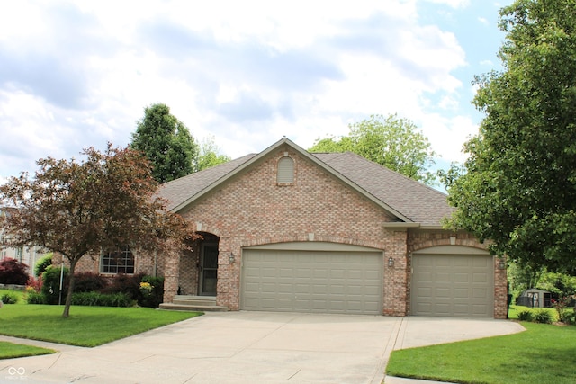 11 Stratford Way, Danville, IN 46122 - view of front facade featuring an attached garage, driveway, a front lawn, and brick siding