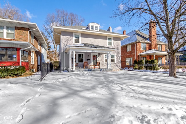 back of property featuring a porch, a fenced front yard, a gate, and stucco siding