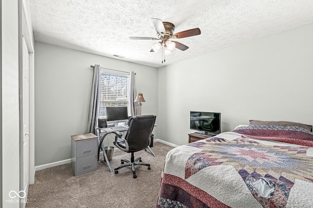 carpeted bedroom with a ceiling fan, visible vents, a textured ceiling, and baseboards