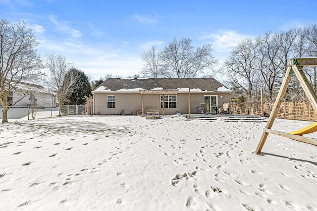 snow covered house with fence