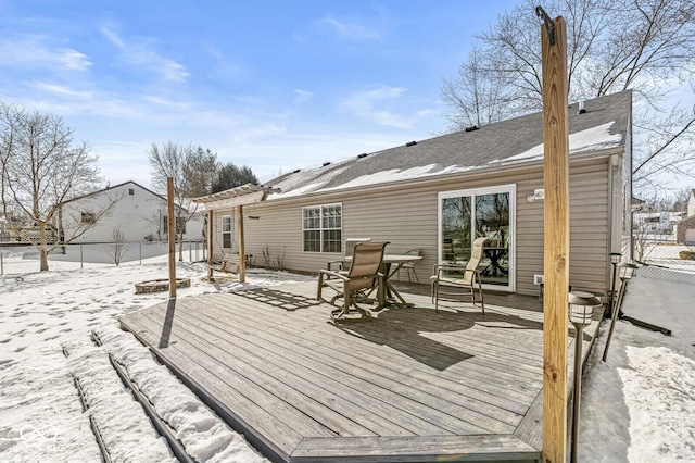 snow covered deck with fence and a pergola