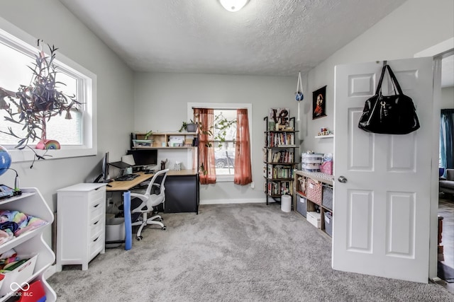 home office featuring light carpet and a textured ceiling