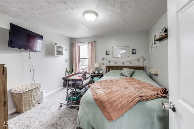 bedroom featuring carpet, a textured ceiling, and baseboards