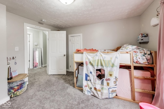 carpeted bedroom featuring a textured ceiling