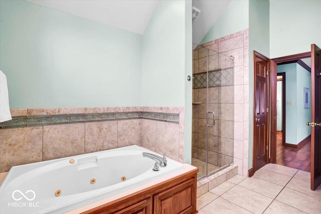 bathroom with tile patterned floors, separate shower and tub, and vaulted ceiling