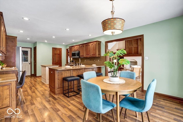 dining room with sink and hardwood / wood-style floors