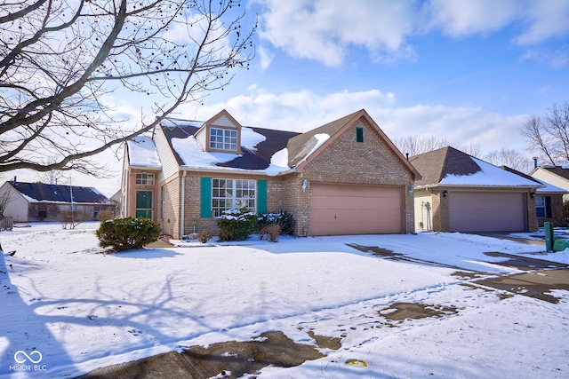 view of front of home featuring a garage and brick siding