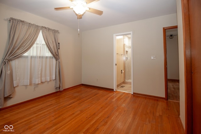 unfurnished bedroom with baseboards, ensuite bath, a ceiling fan, and light wood finished floors