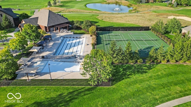 birds eye view of property with a water view and golf course view