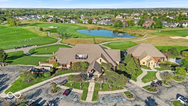 drone / aerial view featuring a water view, a residential view, and golf course view