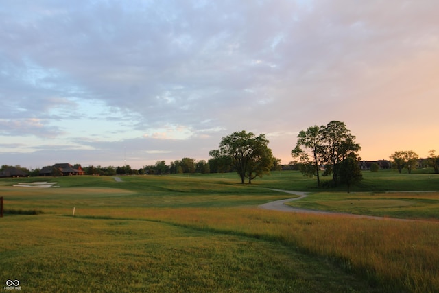 view of community with a lawn and golf course view