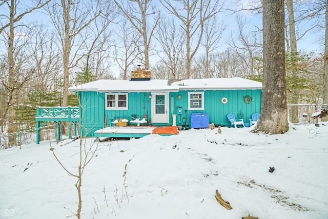 view of front of house with board and batten siding and a chimney