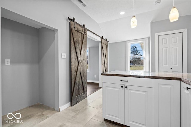 interior space with visible vents, baseboards, and vaulted ceiling