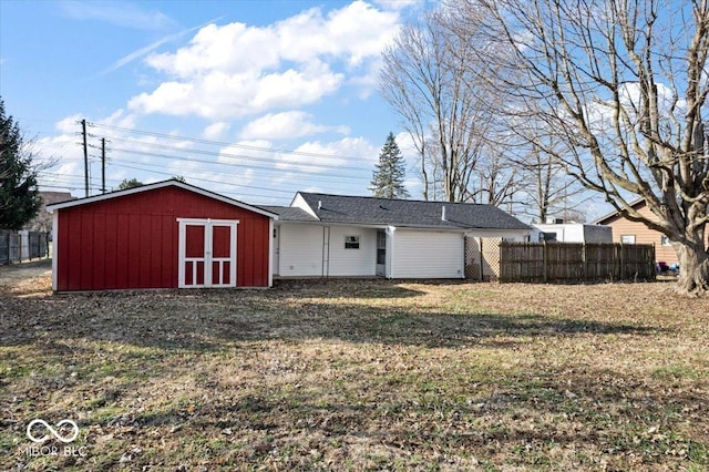 view of shed featuring fence