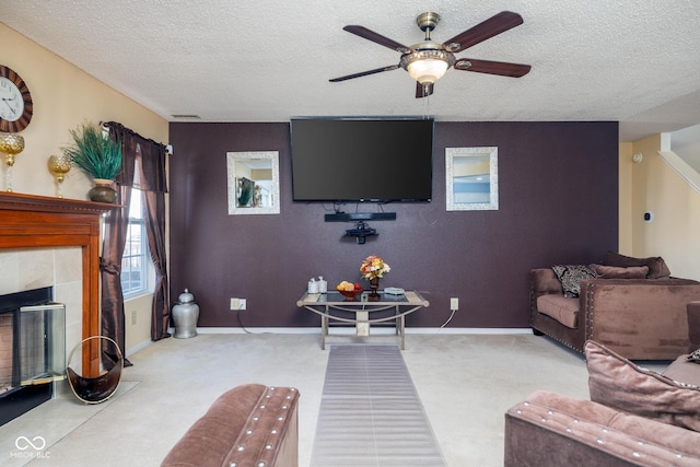 living area with carpet, a textured ceiling, a fireplace, and baseboards