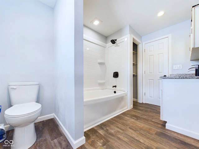 full bath featuring bathtub / shower combination, toilet, wood finished floors, vanity, and baseboards