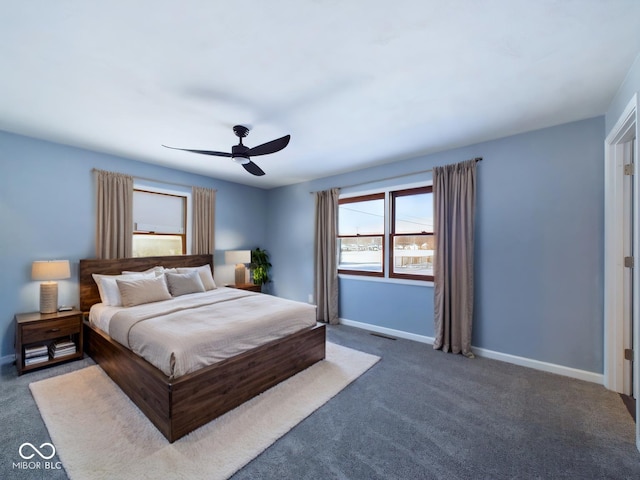 bedroom featuring dark colored carpet, visible vents, ceiling fan, and baseboards