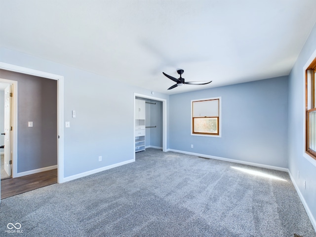 unfurnished bedroom featuring a ceiling fan, carpet, and baseboards