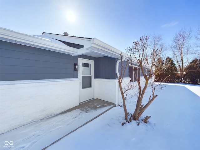 view of snow covered property entrance