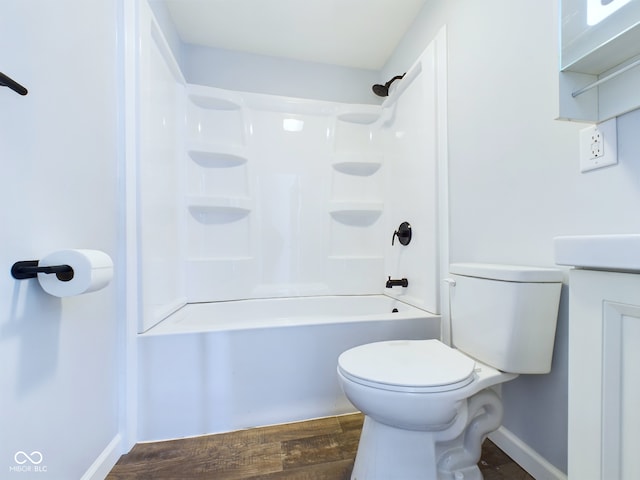 full bathroom featuring baseboards, shower / bathing tub combination, toilet, and wood finished floors