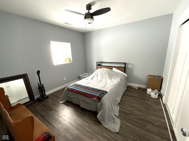 bedroom featuring a ceiling fan, baseboards, visible vents, and dark wood-style flooring