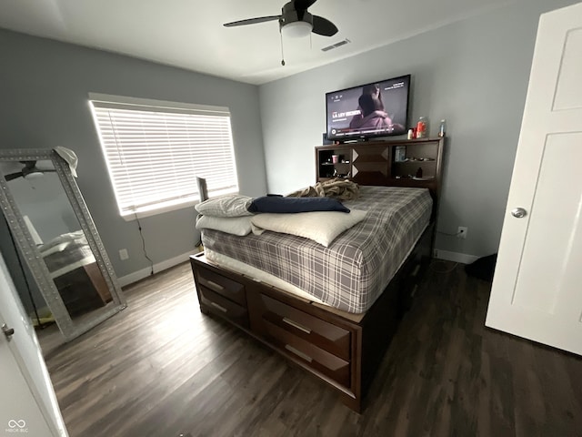 bedroom with dark wood-style floors, visible vents, baseboards, and a ceiling fan