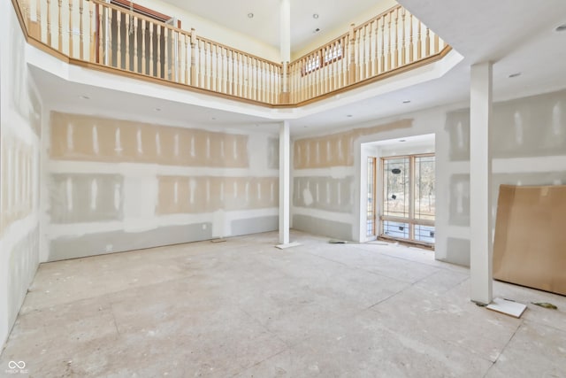 unfurnished room with a high ceiling