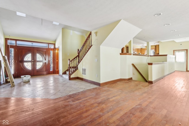 foyer entrance featuring hardwood / wood-style floors, stairway, visible vents, baseboards, and recessed lighting