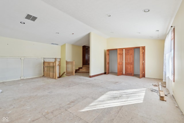 empty room with visible vents and vaulted ceiling