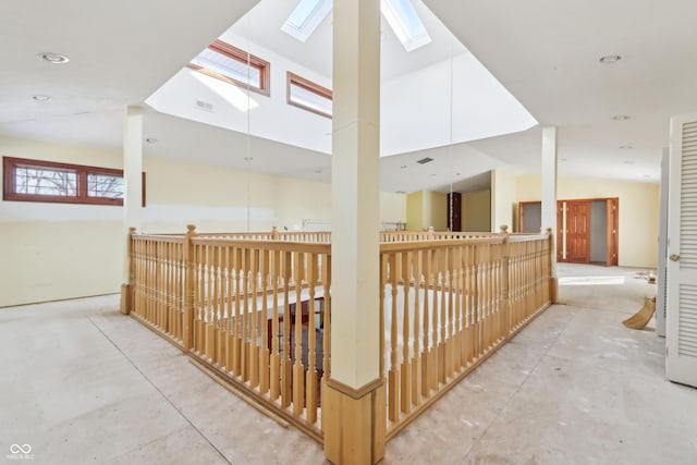 hall with vaulted ceiling with skylight and visible vents