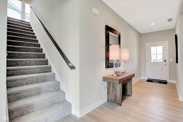 2134 Boxwood Dr, Greenfield, IN 46140 - foyer entrance featuring light wood finished floors, baseboards, visible vents, stairs, and recessed lighting