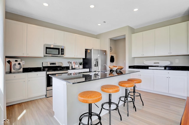 2134 Boxwood Dr, Greenfield, IN 46140 - kitchen with stainless steel appliances, a kitchen island with sink, and white cabinetry