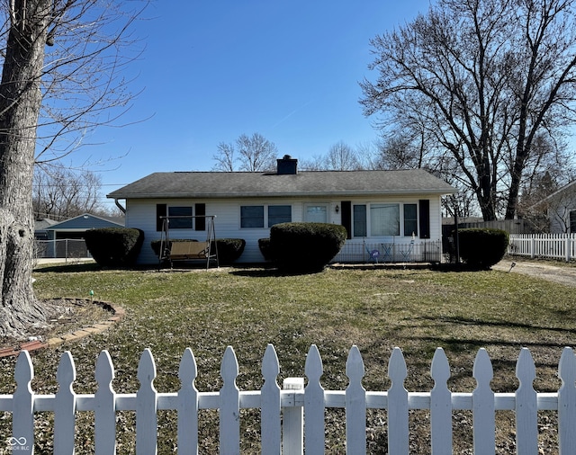 view of front of property featuring a fenced front yard, a chimney, and a front lawn