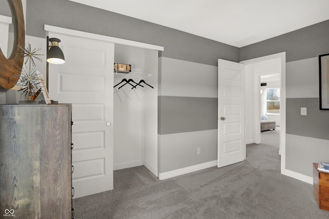 interior space with baseboards and carpet flooring