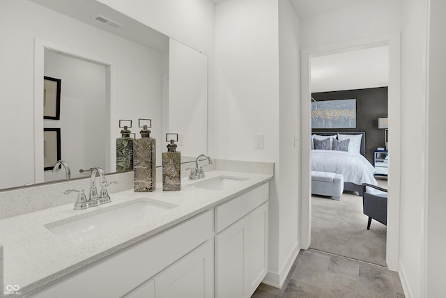 bathroom with a sink, double vanity, ensuite bath, and visible vents