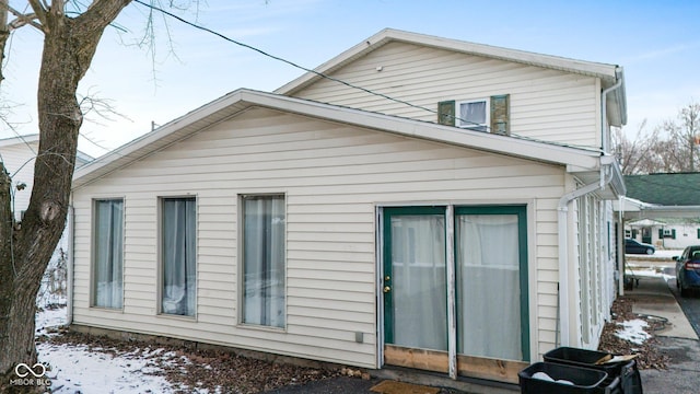 view of snow covered rear of property