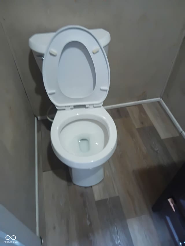 1808 E Washington St, Indianapolis, IN 46201 - bathroom featuring toilet and wood finished floors