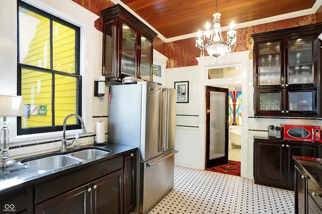 kitchen featuring crown molding, a notable chandelier, high quality fridge, a sink, and wooden ceiling