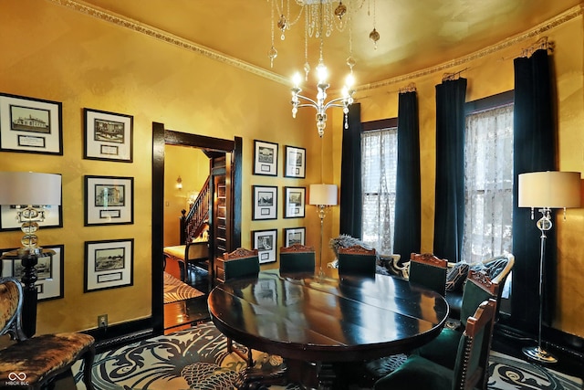 dining space featuring a chandelier and stairway