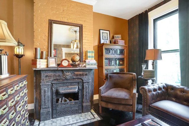 living area featuring a fireplace and a wealth of natural light