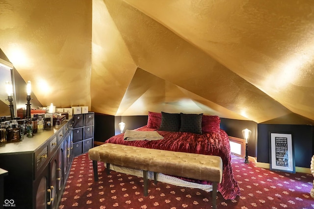 bedroom featuring carpet, vaulted ceiling, and baseboards