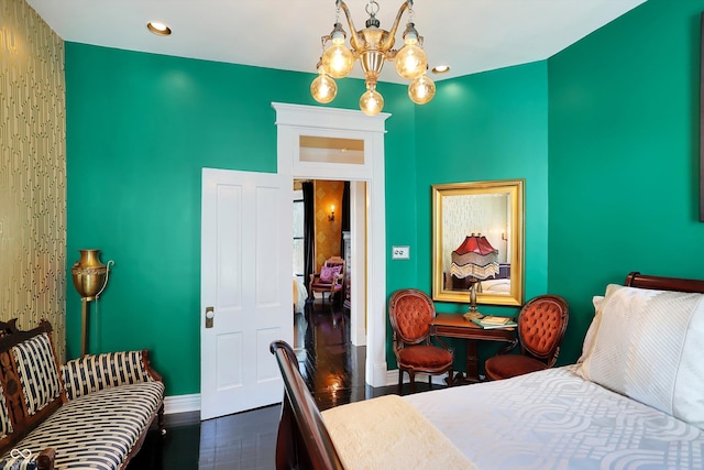 bedroom with dark wood-style floors, recessed lighting, an inviting chandelier, and baseboards