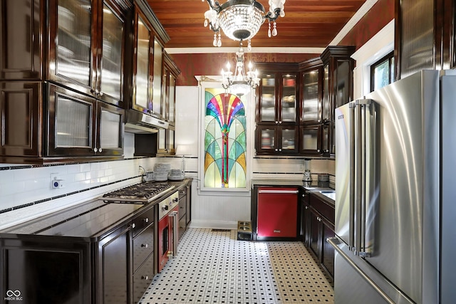 kitchen with wooden ceiling, light floors, an inviting chandelier, stainless steel appliances, and under cabinet range hood