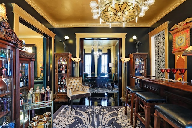 bar with a bar, an inviting chandelier, and ornamental molding