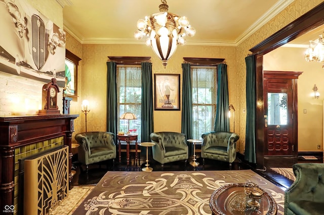 sitting room featuring crown molding, a fireplace, and a notable chandelier